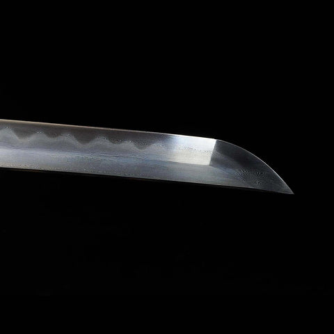 Close-up of the katana tip (kissaki) resting inside saya