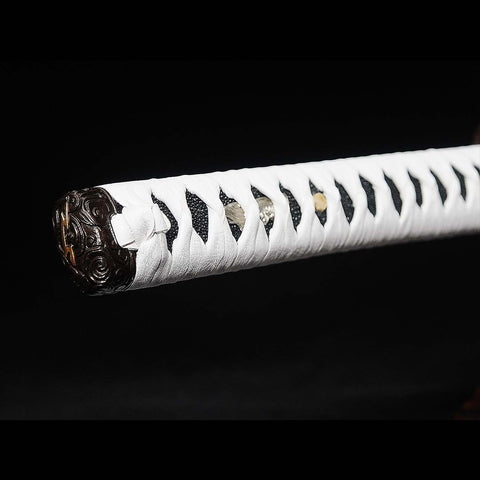 Katana handle partially sheathed, showing tsuka alignment with saya