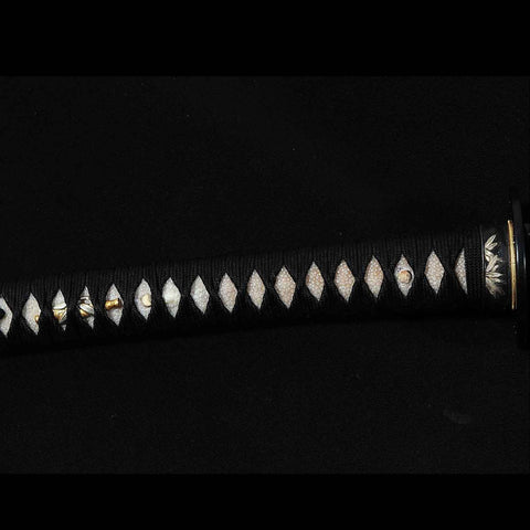 Hardwood tsuka handle wrapped with rayskin and silk ito on Kill Bill katana